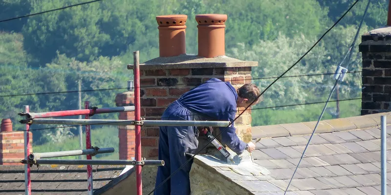 Roofer working on a chimney
