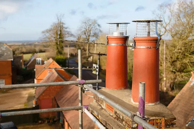 Chimney stack with terracotta pots surrounded by scaffolding during a chimney repair in Knaresborough
